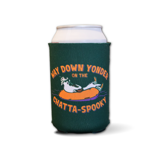 A dark green can cooler sleeve on a silver aluminum can, featuring a cartoon ghost in an orange inner tube with the text 'WAY DOWN YONDER ON THE CHATTA-SPOOKY' on a white background.