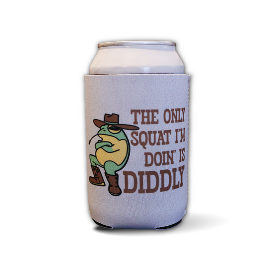 A white aluminum can wrapped in a light gray can cooler sleeve. The sleeve features a cartoon frog wearing a cowboy hat and boots, next to the brown text 'THE ONLY SQUAT I'M DOIN' IS DIDDLY'.